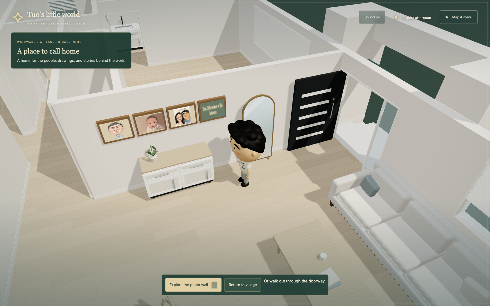 The mascot inside the modeled home, beside a cabinet, mirror, sofa, and the family photo wall