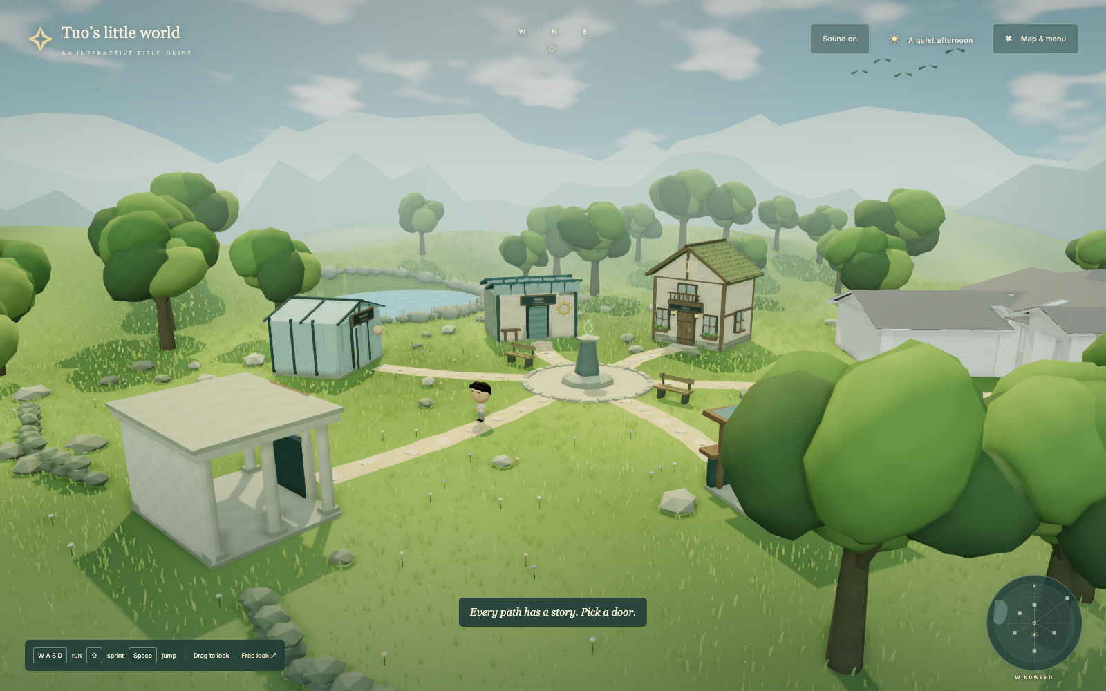 Windward Village in the browser: the mascot on a path between buildings, surrounded by grass, trees, a lake, and distant mountains